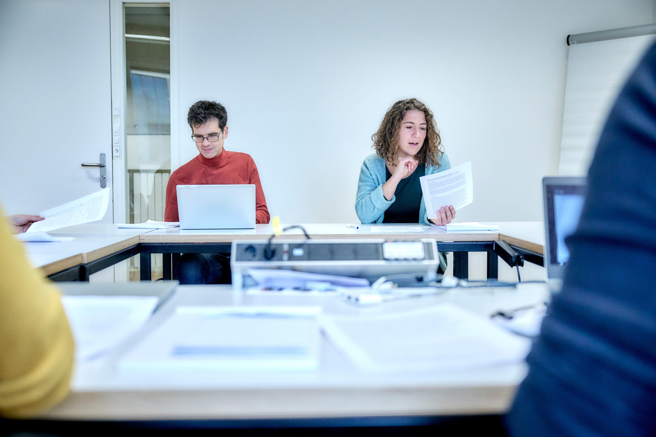 Two people discussing a paper