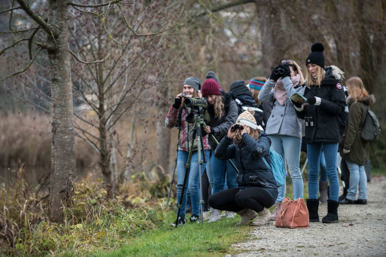 Gruppe von jungen Menschen mit Feldstecher und Fernrohren