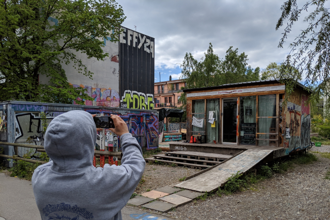 Mann fotografiert Wohncontainer