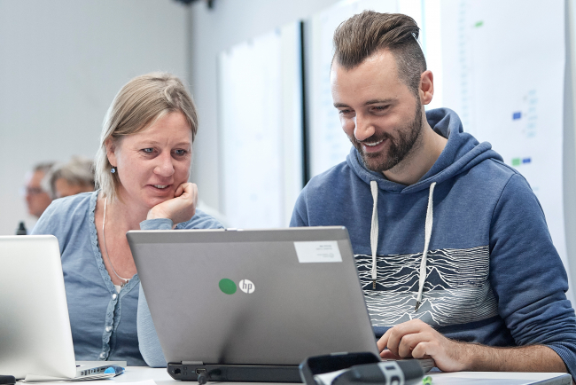 Zwei Lehrpersonen an einem Computer